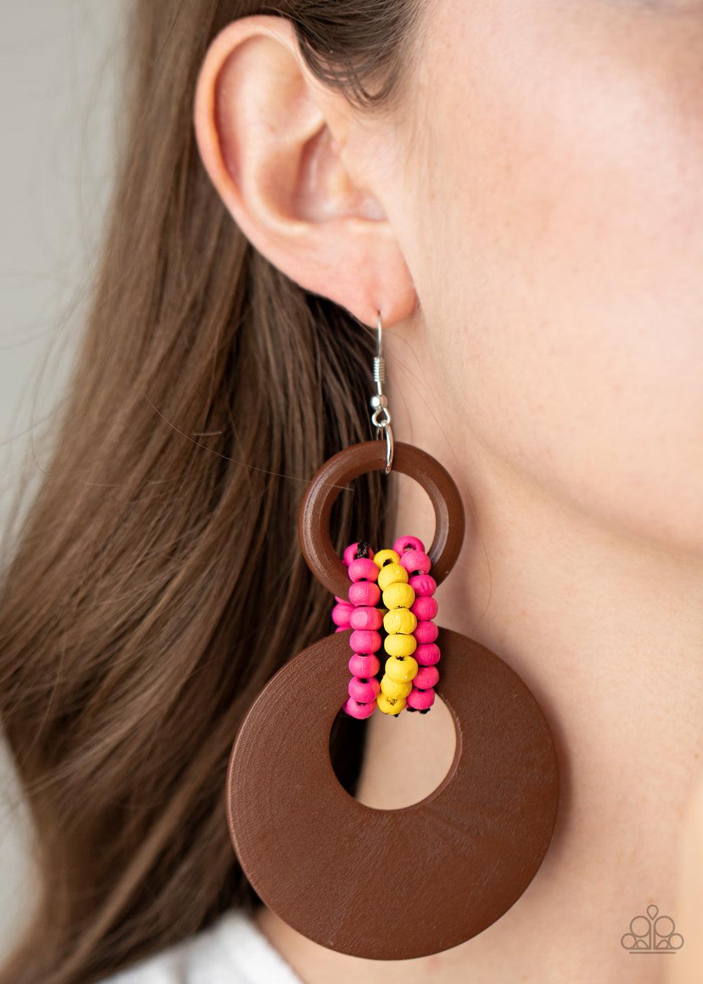Paparazzi Accessories Beach Day Drama - Multi Pink and yellow wooden beaded links connect together a brown wooden ring and an oversized brown wooden crescent-like hoop, creating a vivaciously earthy lure. Earring attaches to a standard fishhook fitting. S