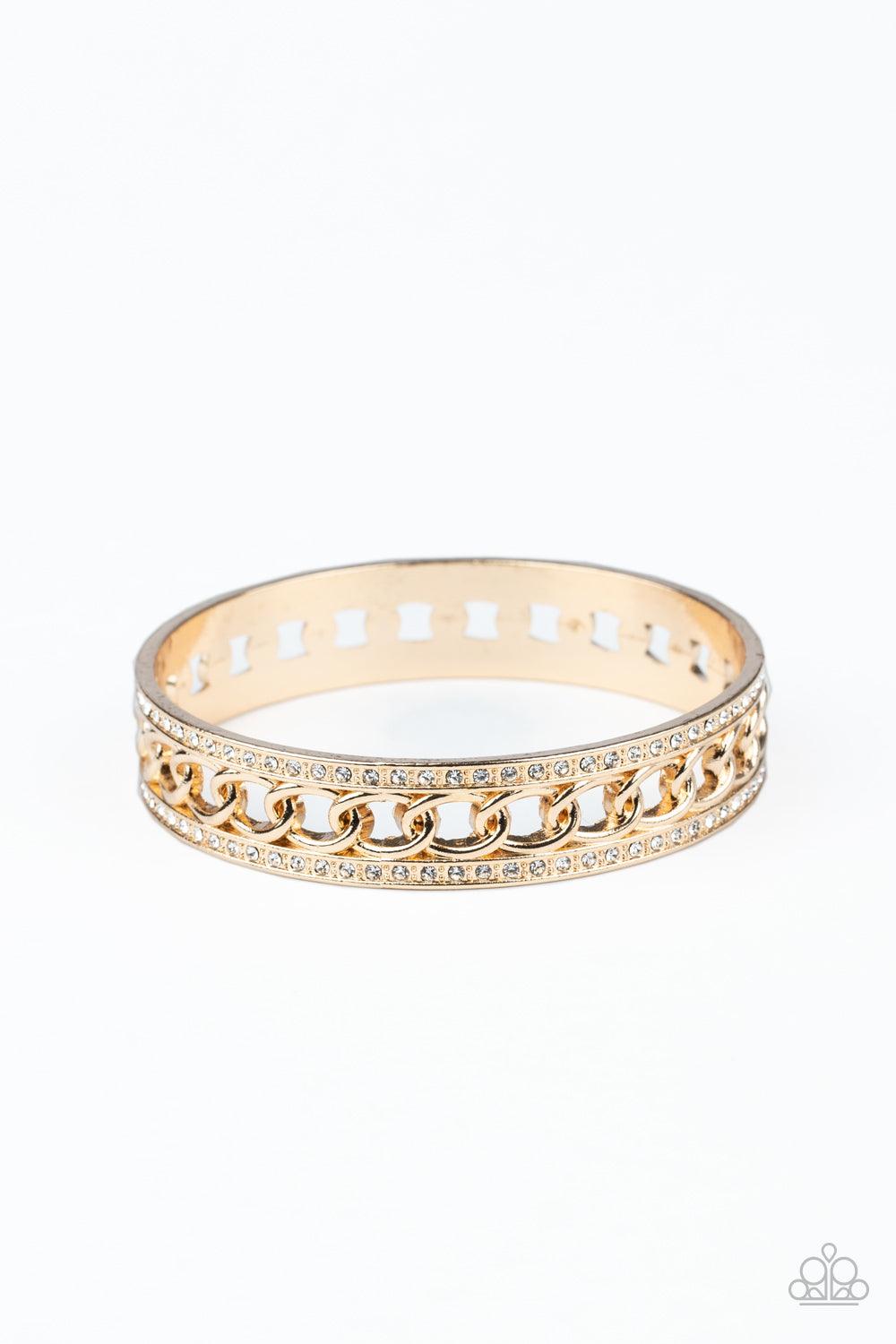 Paparazzi Accessories Couture Court - Gold Bordered in rows of blinding white rhinestones, a glistening strand of gold chain glamorously links around the wrist, coalescing into an unapologetically glittery bangle. Sold as one individual bracelet. Jewelry