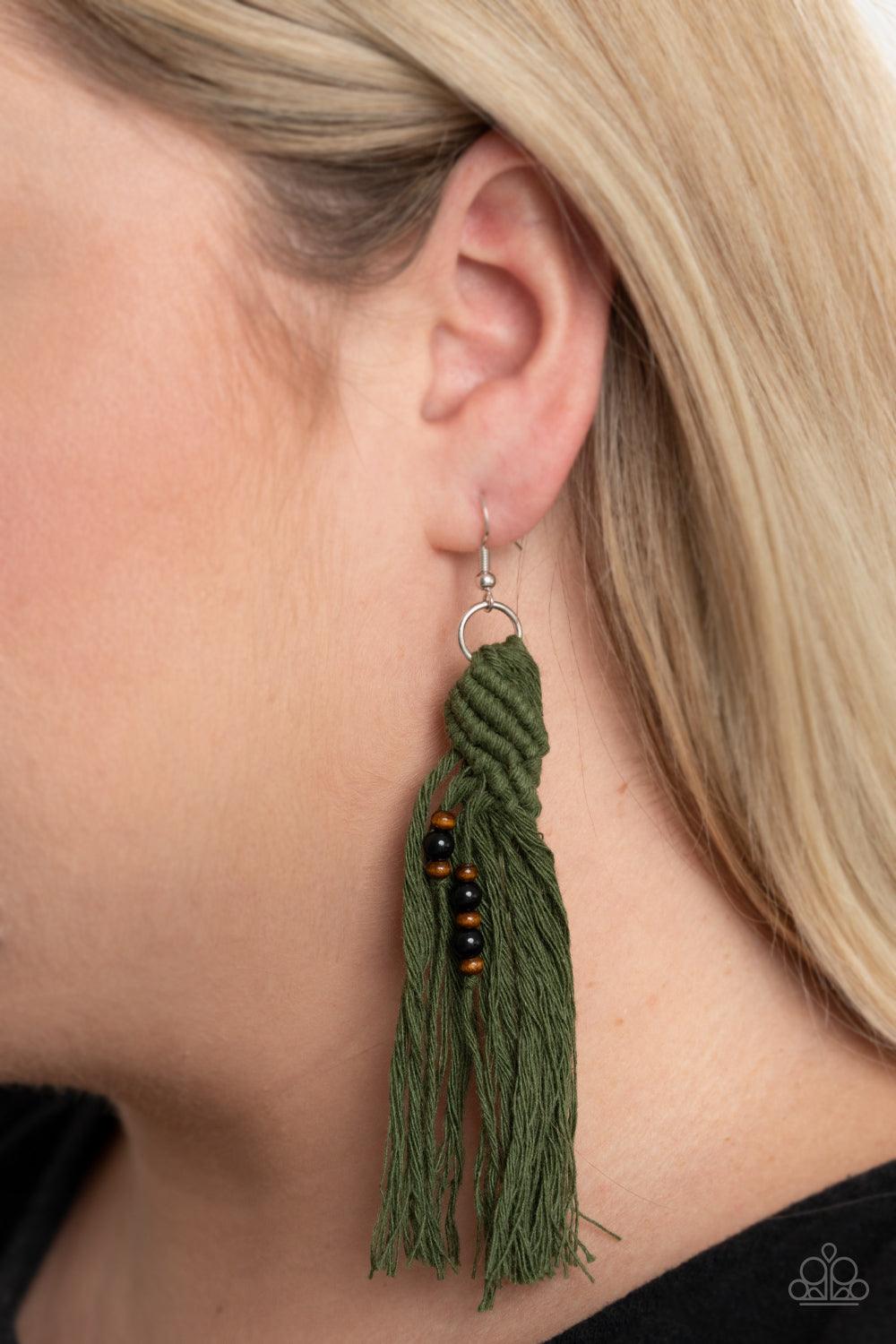 Paparazzi Accessories Beach Bash - Green Dainty wooden and glassy black beads are knotted in place along a knotted Military Olive tassel, creating a beach inspired macramé centerpiece. Earring attaches to a standard fishhook fitting. Sold as one pair of e
