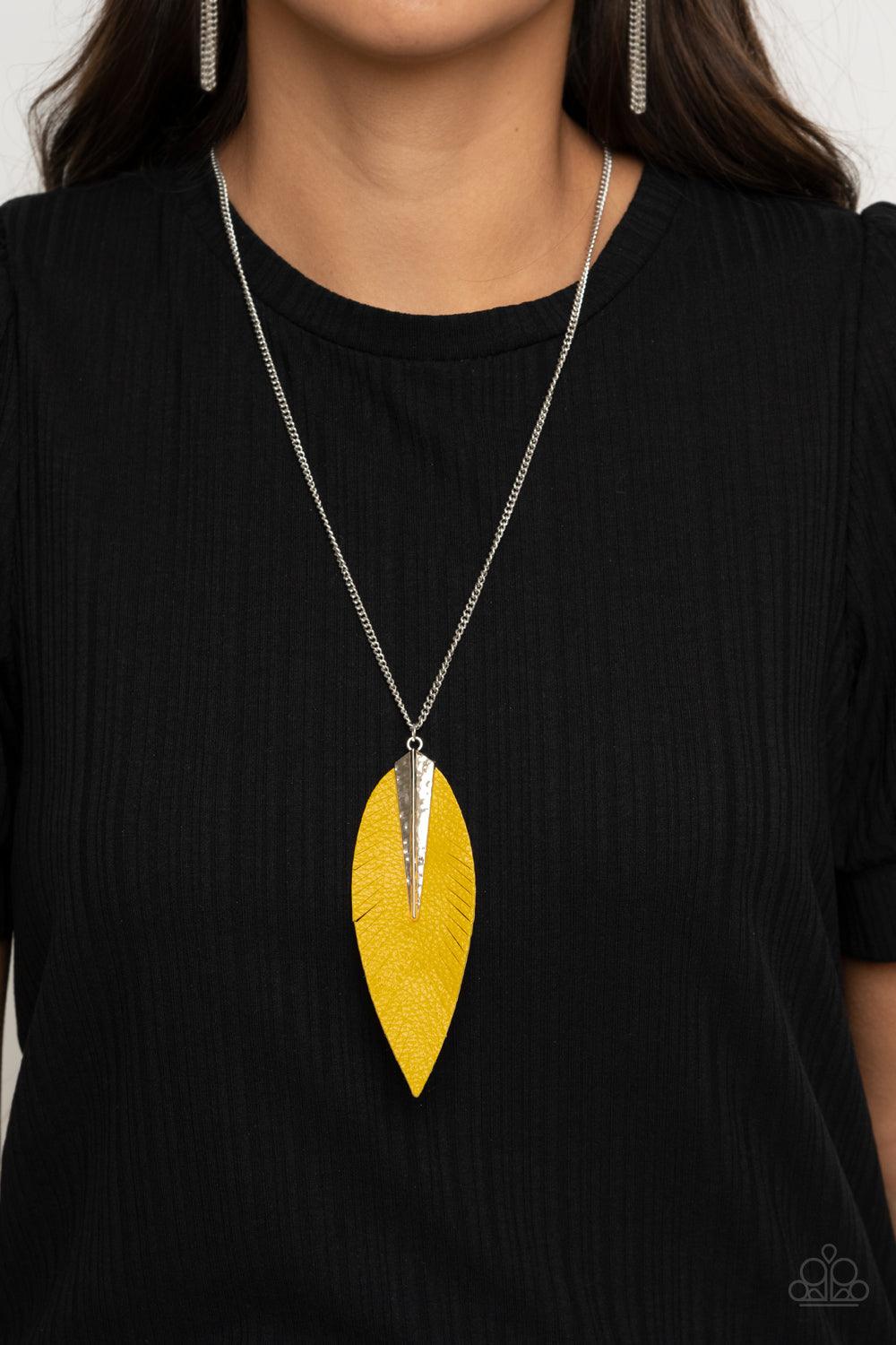 Paparazzi Accessories Quill Quest - Yellow Pinched between a hammered silver fitting, a leaf shaped yellow leather frame is spliced into feathery detail at the bottom of a lengthened silver chain for a free-spirited look. Features an adjustable clasp clos