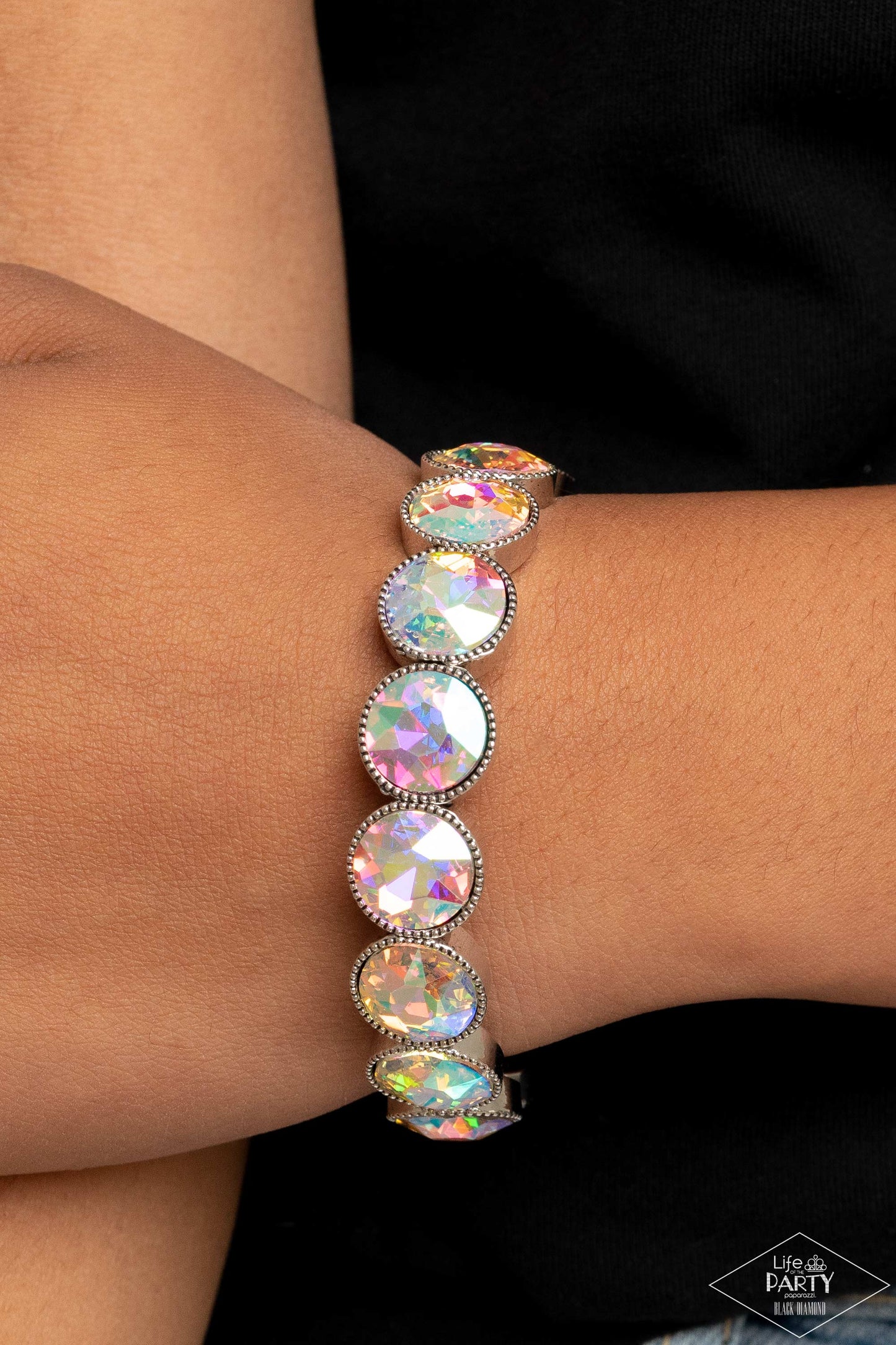 Paparazzi Accessories Number One Knockout - Multi 2 Faceted iridescent gems are pressed into sleek silver frames. The glittery frames are threaded along stretchy bands, creating a glamorous look around the wrist. Due to its prismatic palette, color may va