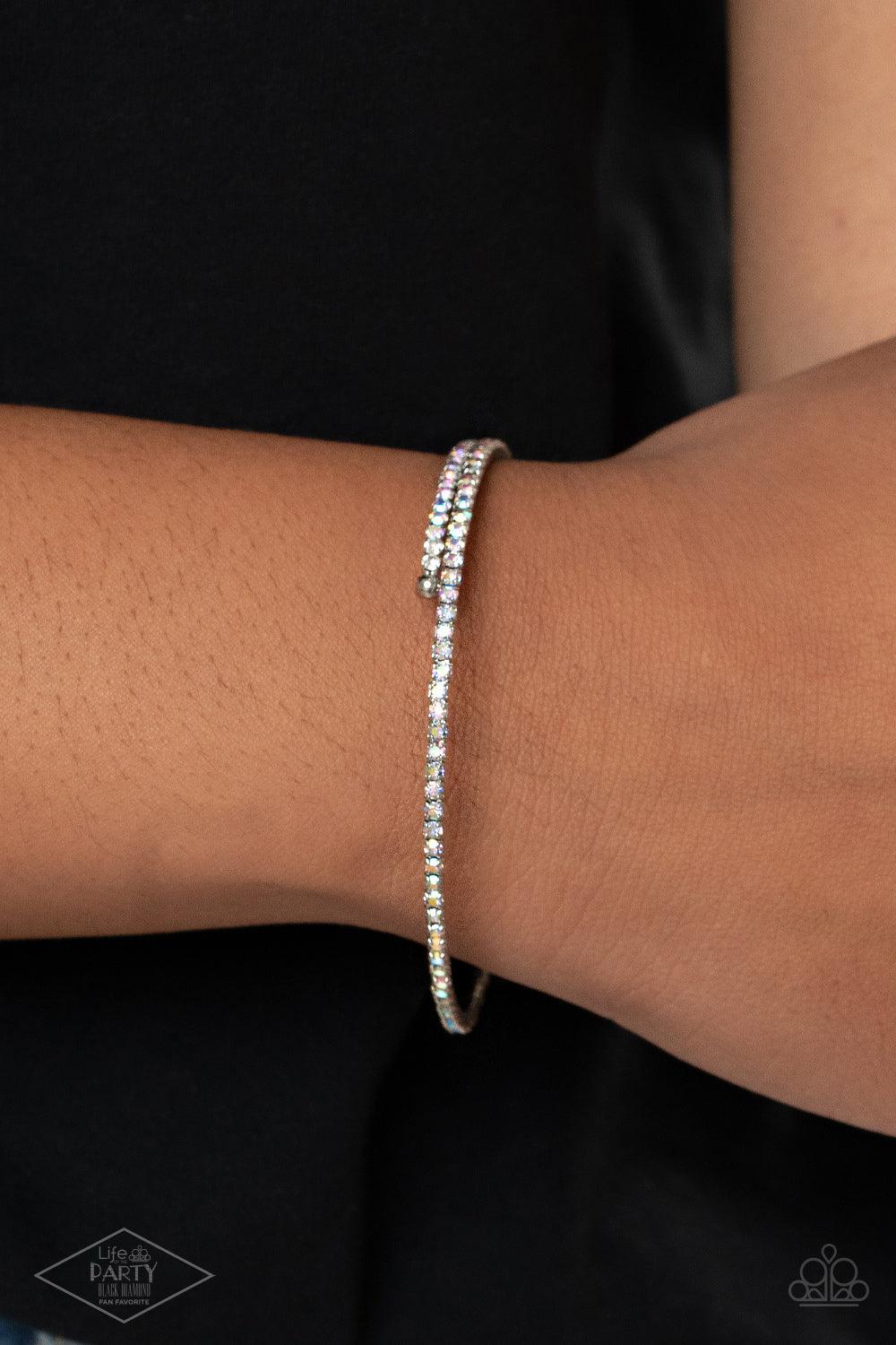 Paparazzi Accessories Sleek Sparkle - Multi Dotted in dainty iridescent rhinestones, a flexible wire coils around the wrist for a refined flair. Sold as one individual bracelet. Jewelry
