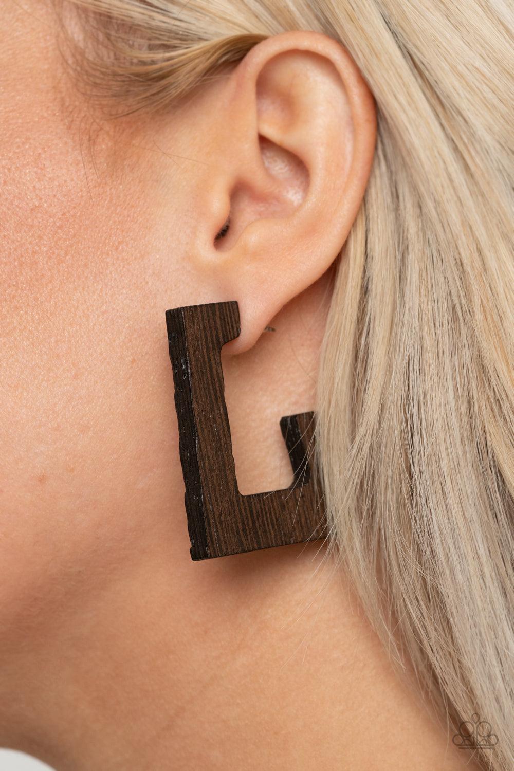 Paparazzi Accessories The Girl Next OUTDOOR - Brown Brushed in a neutral brown finish, a distressed wooden frame curves around the ear, creating a rectangular hoop for a retro effect. Earring attaches to a standard post fitting. Hoop measures approximatel