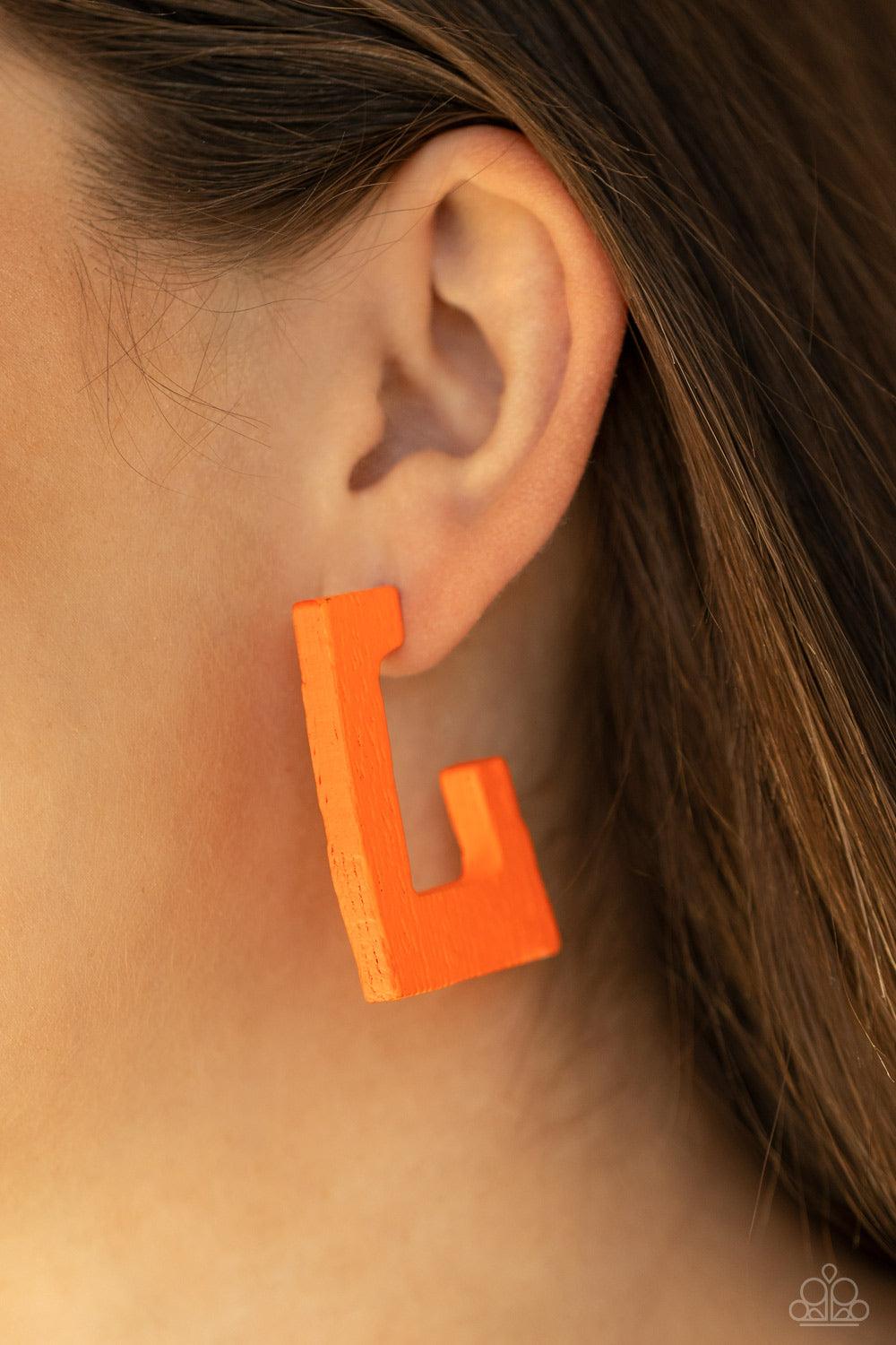 Paparazzi Accessories The Girl Next OUTDOOR - Orange Painted in a neon orange finish, a distressed wooden frame curves around the ear, creating a rectangular hoop for a retro effect. Earring attaches to a standard post fitting. Hoop measures approximately