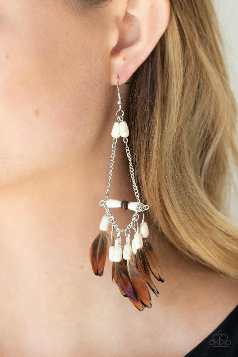 Paparazzi Accessories Haute Hawk - White Infused with a wooden accent, an earthy assortment of white stone teardrop beads and dainty brown feathers create a free-spirited fringe at the bottom of a shimmery silver chain teardrop for a wildly wonderful fini