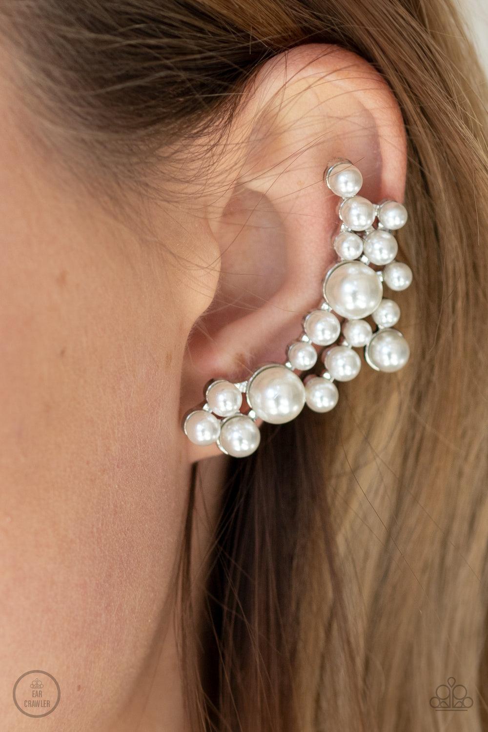 Paparazzi Accessories Metro Makeover - White A collection of bubbly white pearls dot a shiny silver frame that branches up the ear for a modern, timeless twist. Earring attaches to a standard post fitting. Features a clip-on fitting at the top for a secur