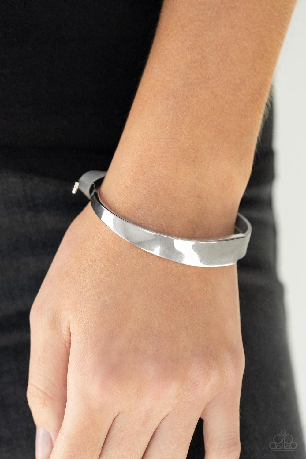 Paparazzi Accessories A Notch Above The Rest - Silver A hammered silver bead glides along two strands of gray leather that attach to an asymmetrical silver bar that curls out into a hook. Features a hook closure. Sold as one individual bracelet. Jewelry