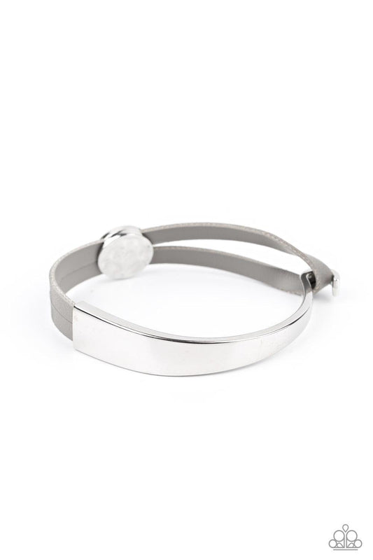 Paparazzi Accessories A Notch Above The Rest - Silver A hammered silver bead glides along two strands of gray leather that attach to an asymmetrical silver bar that curls out into a hook. Features a hook closure. Sold as one individual bracelet. Jewelry
