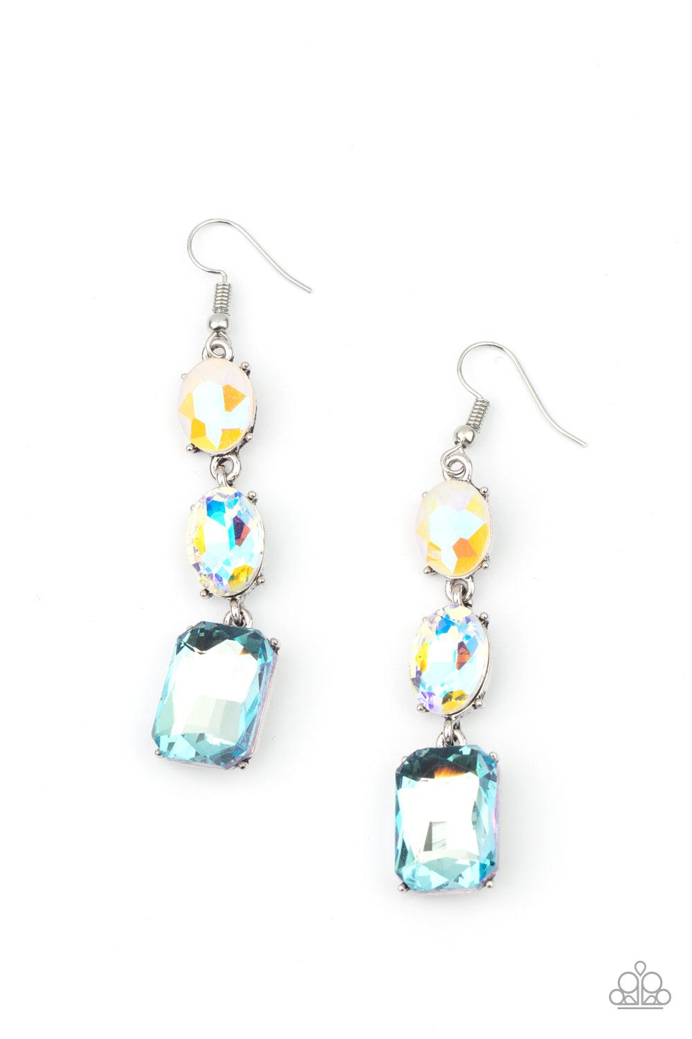 Paparazzi Accessories Dripping In Melodrama - Blue A blue emerald style gem swings from the bottom of a mismatched pair of iridescent and milky opalescent oval rhinestones, creating a stellar lure. Earring attaches to standard fishhook fitting. Sold as on