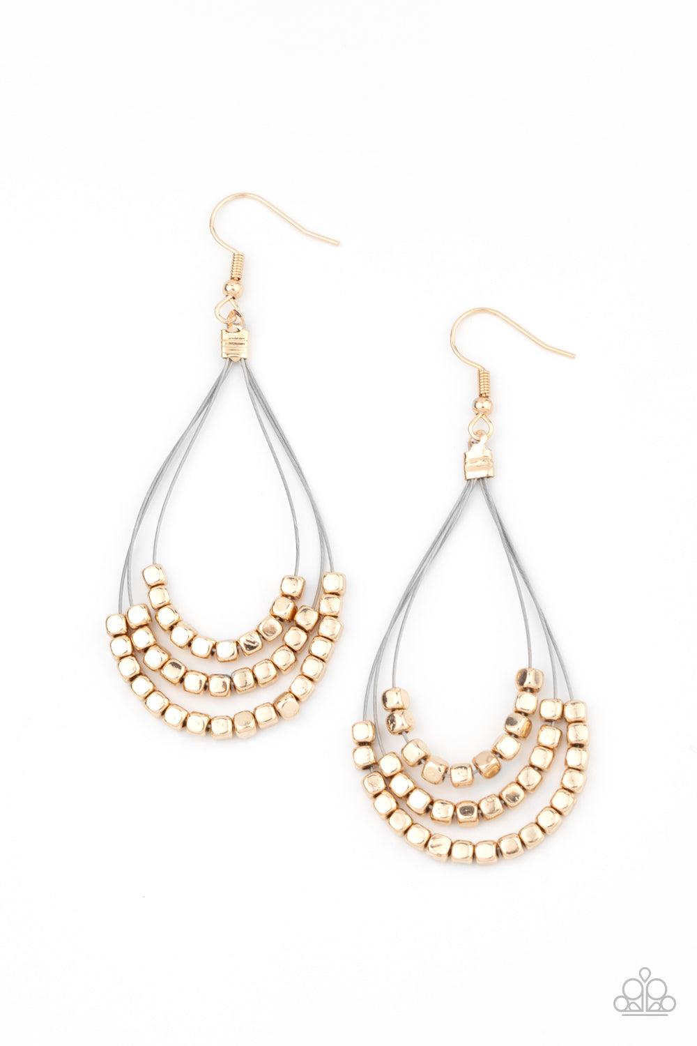 Paparazzi Accessories Off The Blocks Shimmer - Gold Three rows of dainty gold cube beads glides along shiny thin wire, layering into an edgy teardrop lure. Earring attaches to a standard fishhook fitting. Sold as one pair of earrings. Jewelry