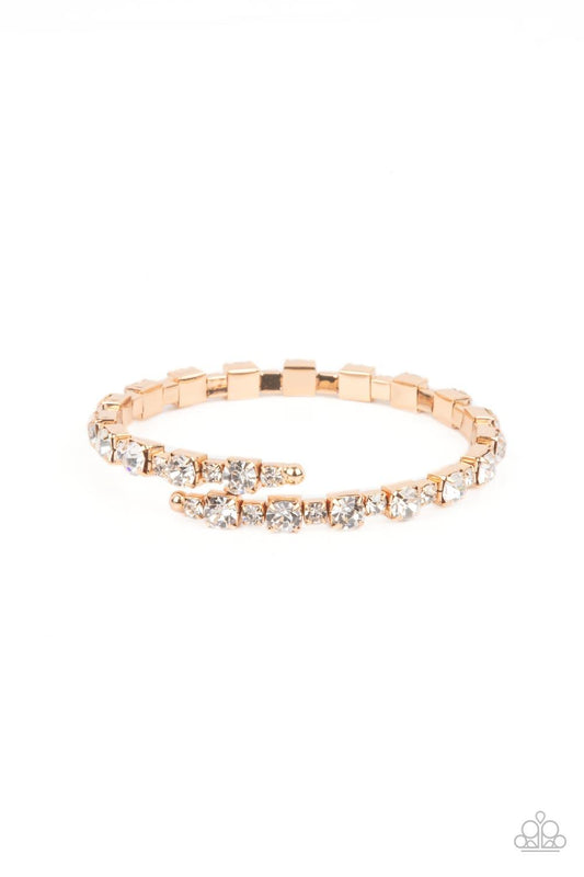 Paparazzi Accessories Photo Op - Gold Featuring gold square fittings, dainty and classic white rhinestones delicately alternate along a flexible wire, coiling into a glamorous centerpiece around the wrist. Sold as one individual bracelet. Jewelry