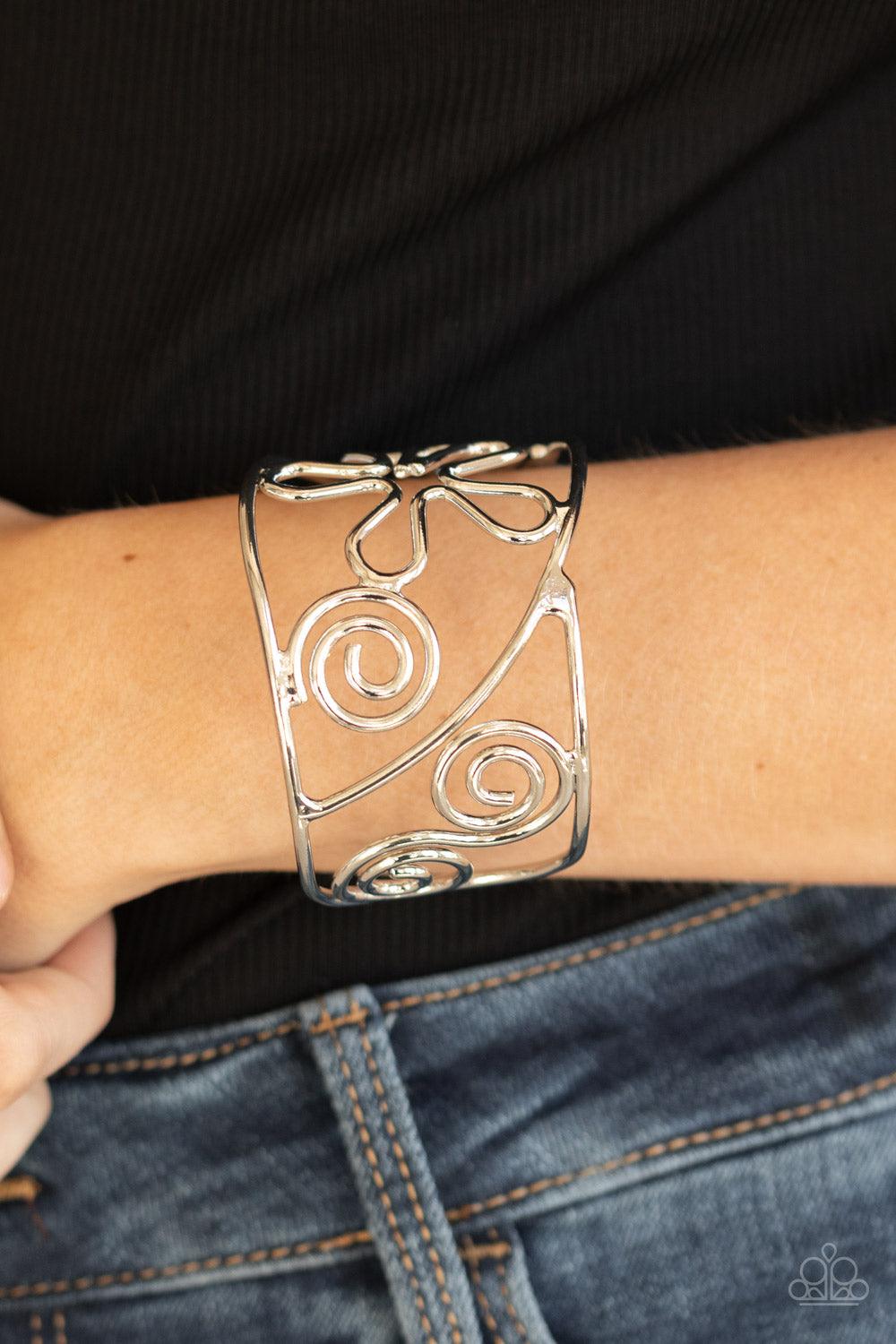 Paparazzi Accessories Groovy Sensations - Silver Shiny silver wire bends and curls into groovy floral and swirl frames, coalescing into a psychedelic cuff around the wrist. Sold as one individual bracelet. Jewelry