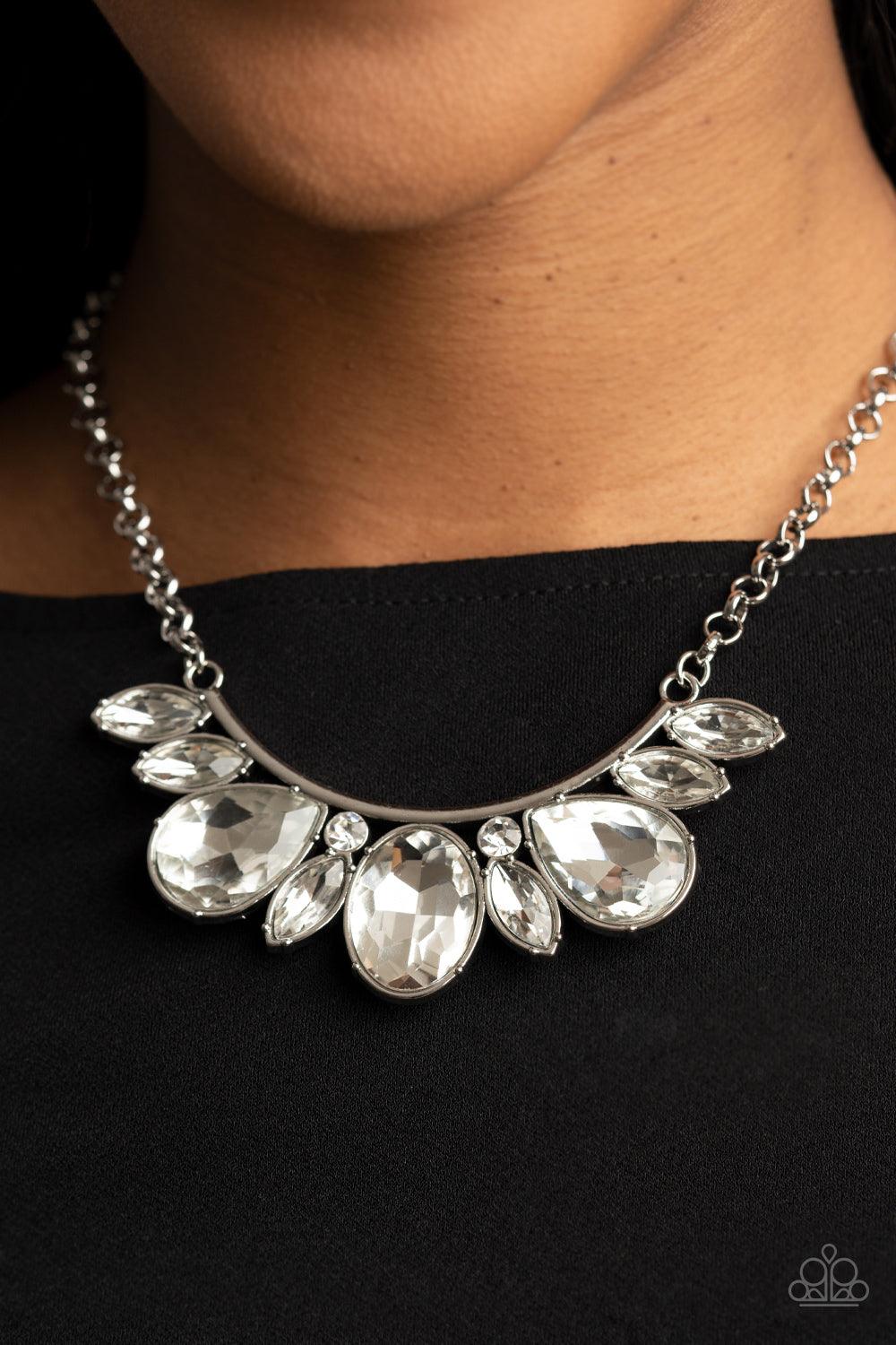 Paparazzi Accessories Never SLAY Never - White An oversized collection of round, marquise, and teardrop white rhinestones drip from the bottom of a bowing silver bar, coalescing into a sassy statement piece below the collar. Features an adjustable clasp c
