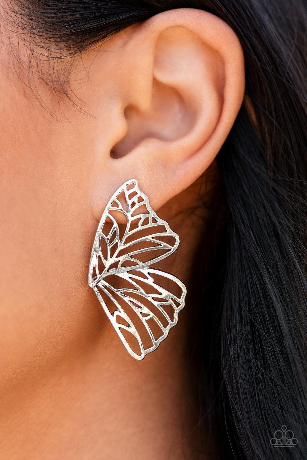 Paparazzi Accessories Butterfly Frills - Silver Shimmery silver bars delicately climb scalloped silver frames, coalescing into a whimsical butterfly wing. Earring attaches to a standard post fitting. Sold as one pair of double-sided post earrings. Jewelry