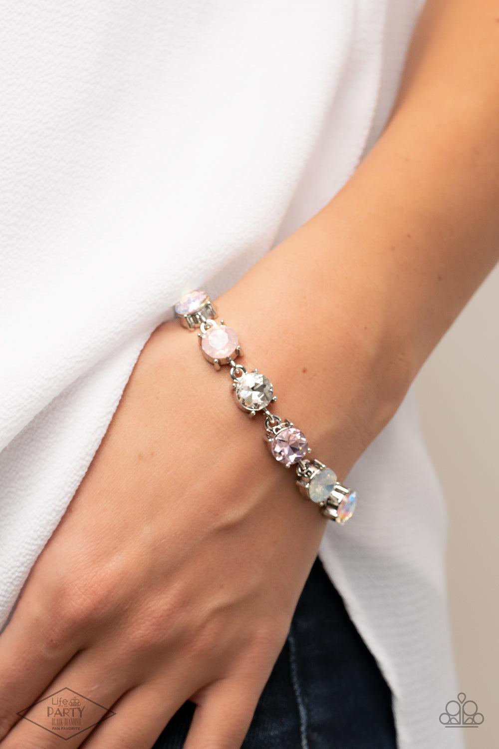 Paparazzi Accessories Celestial Couture - Pink An oversized collection of icy, pink, white, and iridescent rhinestones delicately link around the wrist for a stellar shimmer. Features an adjustable clasp closure. Sold as one individual bracelet. Bracelets