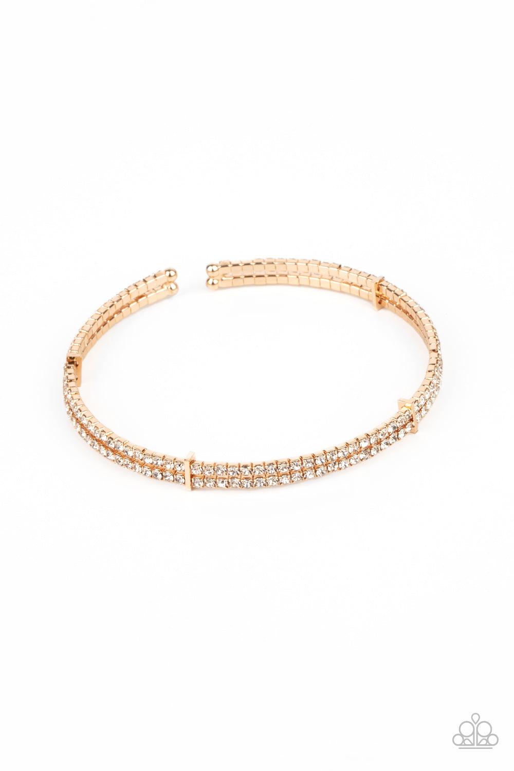 Paparazzi Accessories Standout Opulence - Gold Held together with dainty gold fittings, two glittery strands of white rhinestones delicately curl around the wrist for a timeless finish. Sold as one individual bracelet. Jewelry