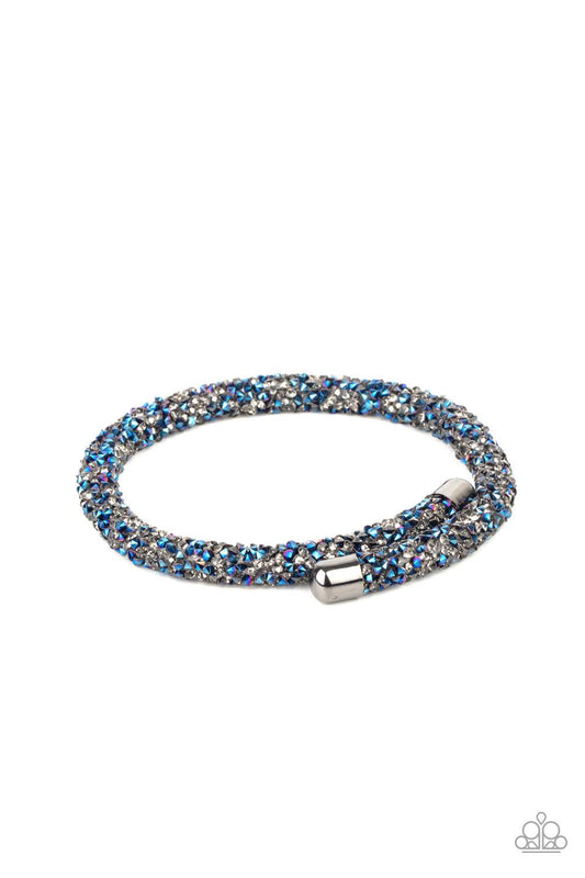 Paparazzi Accessories Roll Out The Glitz - Multi As if rolled in glitter, a seemingly infinite collection of metallic blue and smoky rhinestones adorns a flexible band that delicately coils around the wrist for a sparkly versatile fit. Sold as one individ