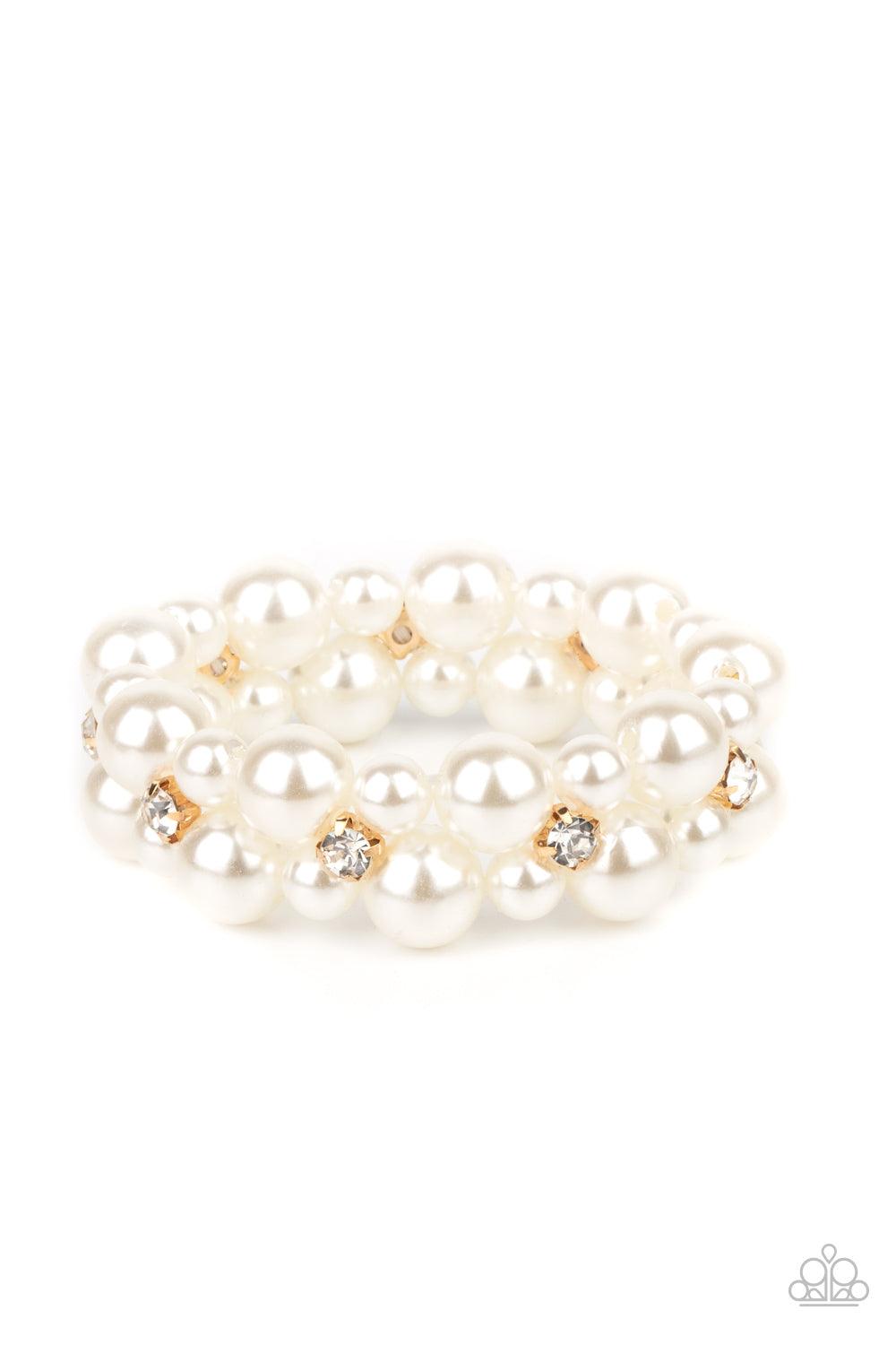 Paparazzi Accessories Flirt Alert - Gold A bubbly collection of white pearls and classic white rhinestone encrusted gold frames are threaded along stretchy bands around the wrist, creating flirtatious refinement. Sold as one individual bracelet. Bracelets