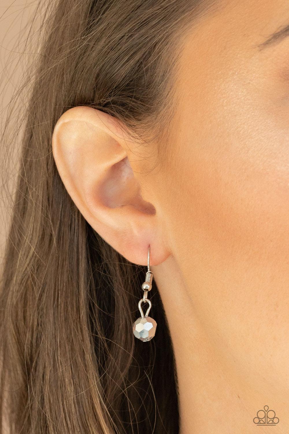 Paparazzi Accessories Mega Modern - Silver A glassy white teardrop swings from the bottom of a chunky silver chain that attaches to a shimmery silver popcorn chain, creating a modern display below the collar. Features an adjustable clasp closure. Sold as