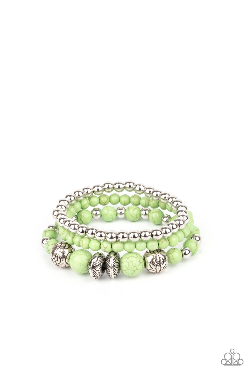 Paparazzi Accessories Desert Blossom - Green A whimsically mismatched collection of green stone beads, plain silver beads, and antiqued floral accents are threaded along stretchy bands around the wrist, creating colorful layers. Sold as one set of three b