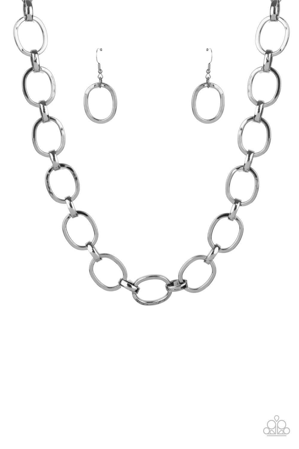 Paparazzi Accessories HAUTE-ly Contested - Black A glistening series of dramatically oversized ovals and links boldly connect below the collar, creating an intense industrial statement. Features an adjustable clasp closure. Sold as one individual necklace