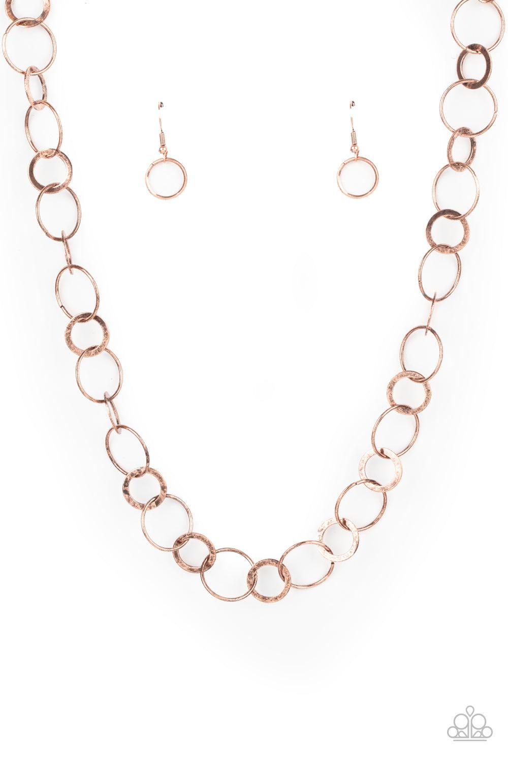 Paparazzi Accessories Revolutionary Radiance - Copper Dainty copper hoops and rustic rings delicately link into a chic chain, creating simplistic shimmer below the collar. Features an adjustable clasp closure. Sold as one individual necklace. Includes one