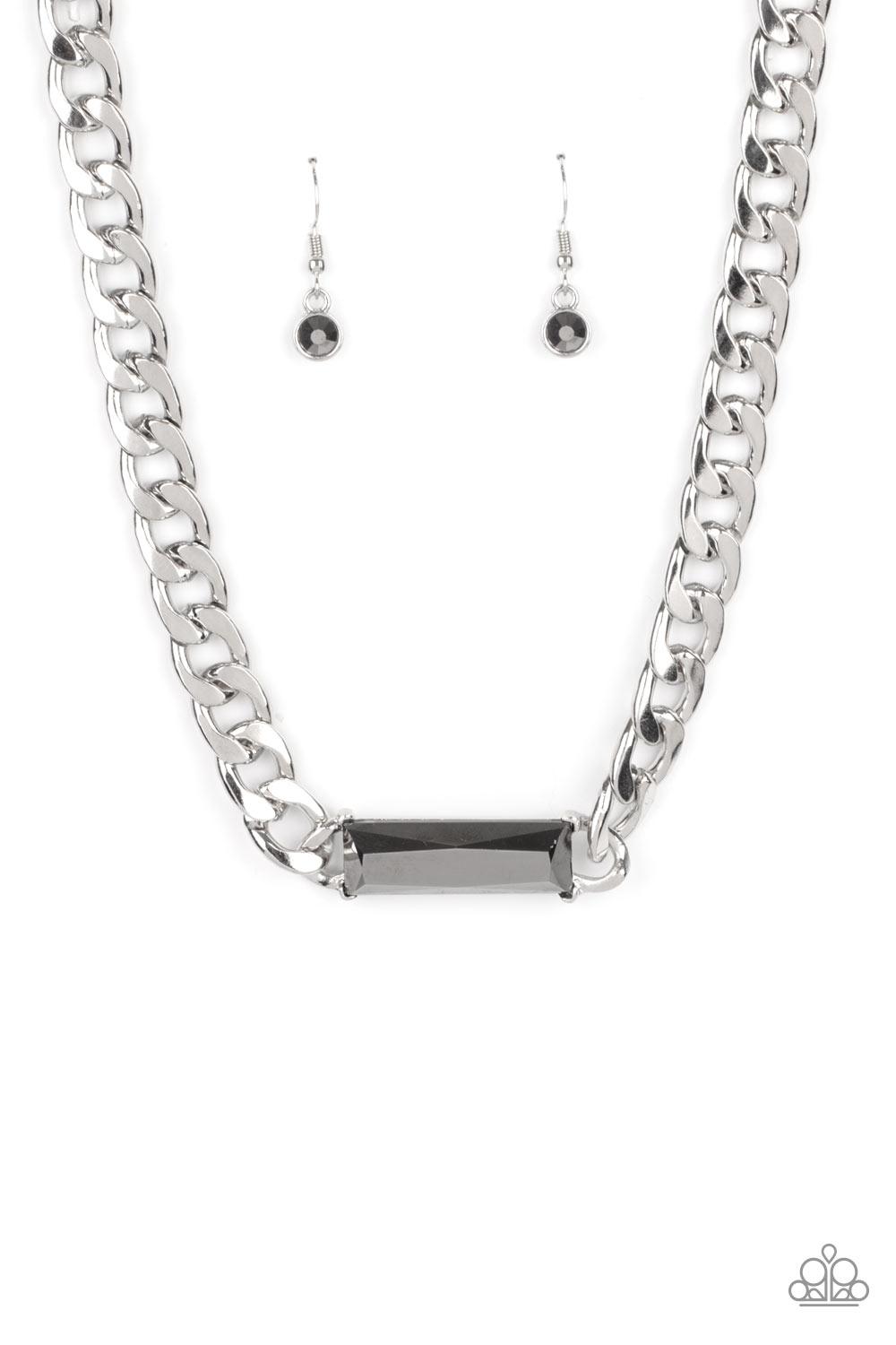 Paparazzi Accessories Urban Royalty - Silver A dramatically oversized row of silver chain attaches to an emerald cut hematite rhinestone pendant, creating a demanding centerpiece below the collar. Features an adjustable clasp closure. Sold as one individu