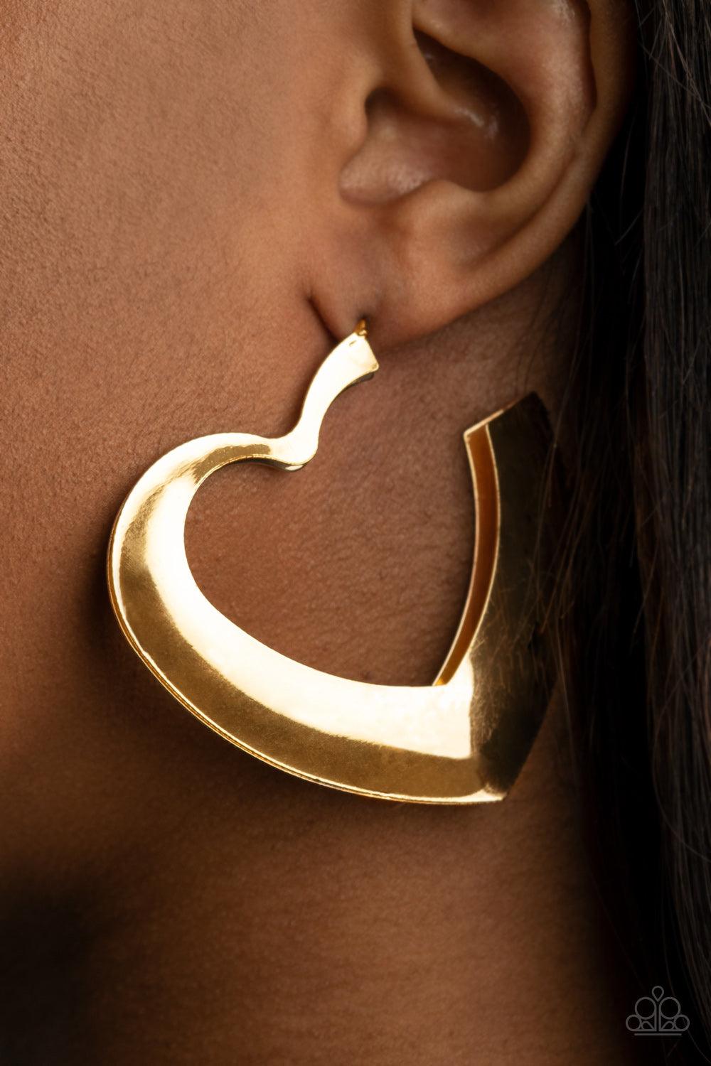 Paparazzi Accessories Heart-Racing Radiance - Gold Flat gold frames delicately collect into a voluminous heart shaped hoop for a flirtatious display. Earring attaches to a standard post fitting. Hoop measures approximately 2 1/4" in diameter. Sold as one