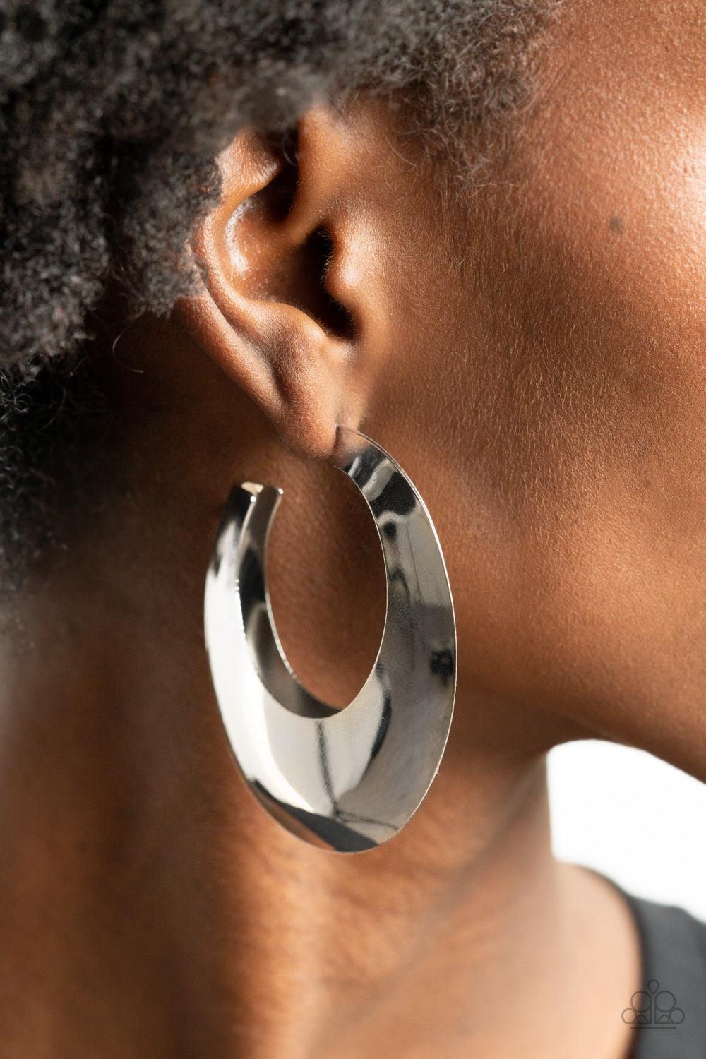 Paparazzi Accessories Going OVAL-board - Silver Two silver frames join into a beveled oval shaped hoop, creating a bold pop of metallic shimmer. Earring attaches to a standard post fitting. Hoop measures approximately 1 3/4" in diameter. Sold as one pair