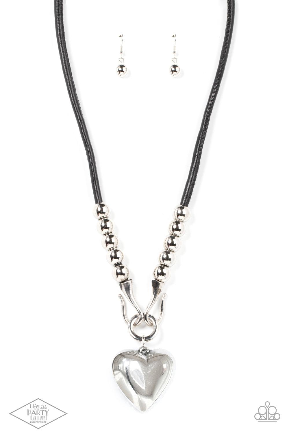 Paparazzi Accessories Forbidden Love - Black Featuring chunky silver beads, an oversized silver heart pendant swings from dramatic silver hook-like fittings that attach to a bold leather cord draped across the chest for a haute heartbreaker look. Features