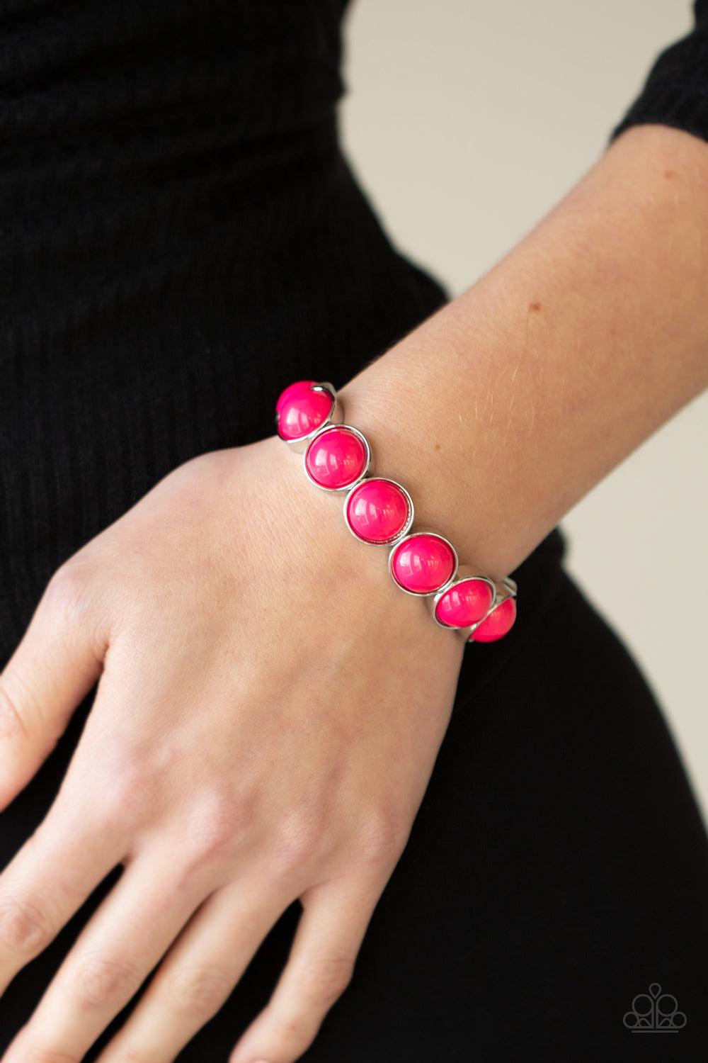 Paparazzi Accessories POP, Drop, and Roll - Pink Featuring flamboyant pink beaded centers, bubbly silver frames are threaded along stretchy bands around the wrist for a powerful pop of color. Sold as one individual bracelet. Jewelry