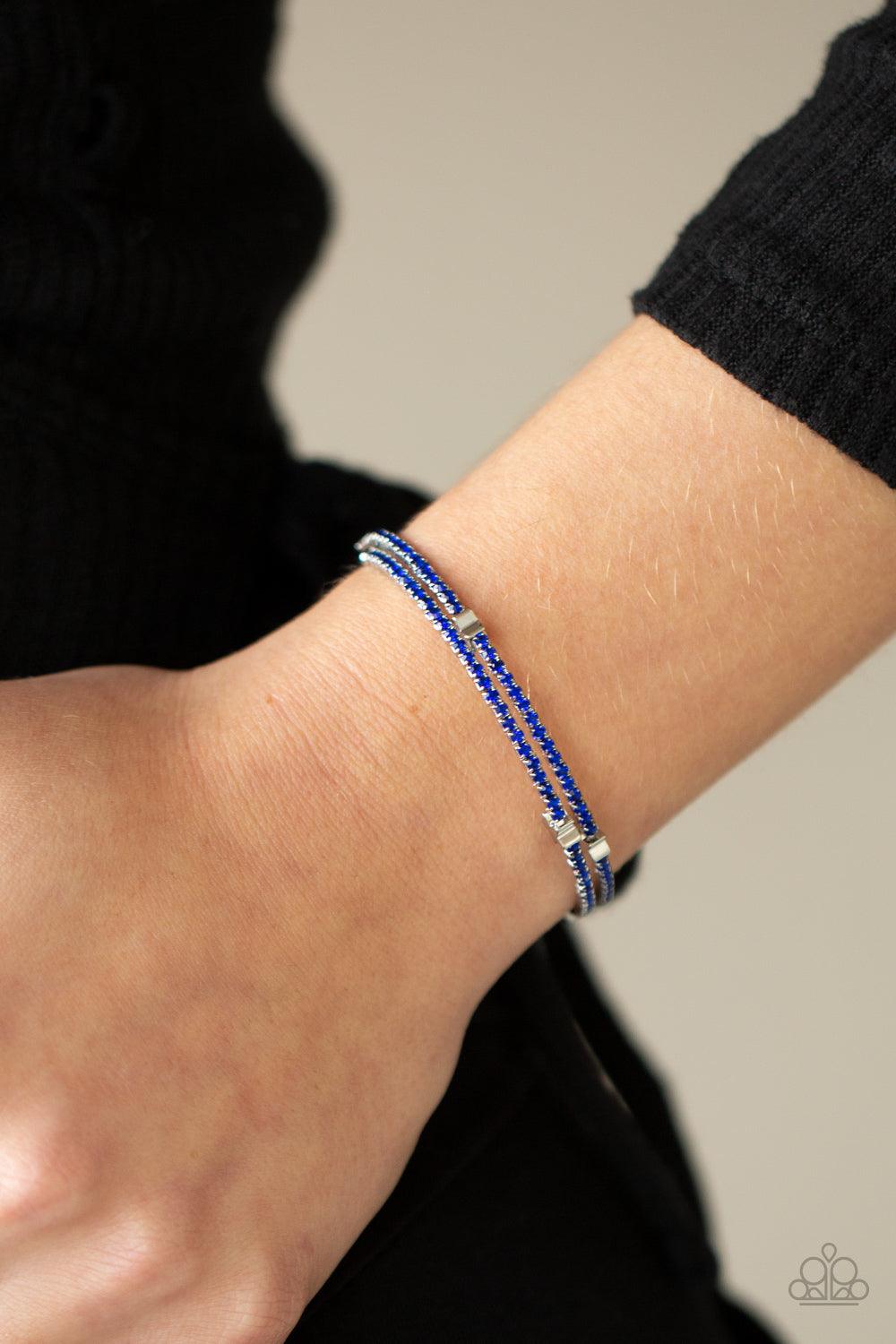 Paparazzi Accessories Let Freedom BLING - Blue Dotted with dainty silver star charms, a bendable row of glittery blue rhinestones spirals around the wrist, creating a sparkly infinity wrap bracelet. Sold as one individual bracelet. Jewelry