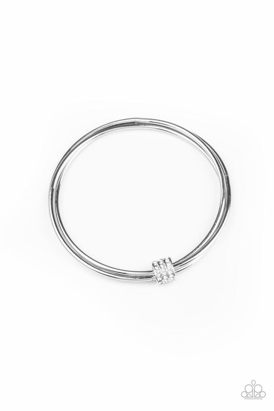 Paparazzi Accessories Roll Out The Rhinestones - White A white rhinestone encrusted fitting glides along a trio of silver bangles, creating a solitaire bracelet around the wrist. Sold as one individual bracelet. Jewelry