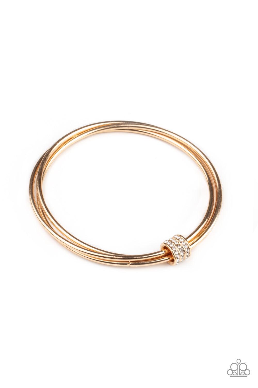 Paparazzi Accessories Roll Out The Rhinestones - Gold A white rhinestone encrusted fitting glides along a trio of gold bangles, creating a solitaire bracelet around the wrist. Sold as one individual bracelet. Jewelry