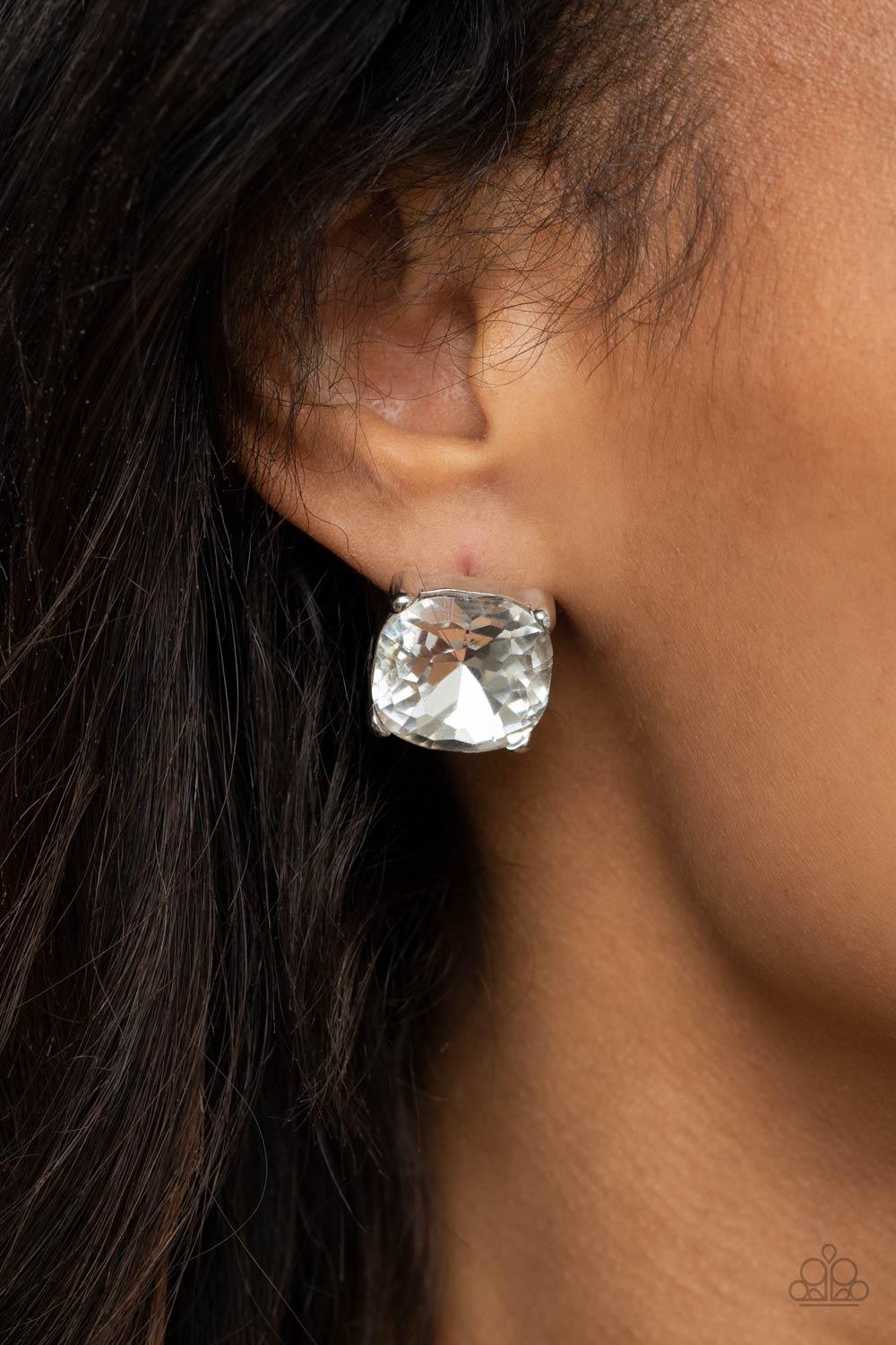 Paparazzi Accessories Royalty High - White A dramatically oversized white gem is nestled atop a pronged silver frame, creating a jaw-dropping dazzle. Earring attaches to a standard post fitting. Sold as one pair of post earrings. Jewelry