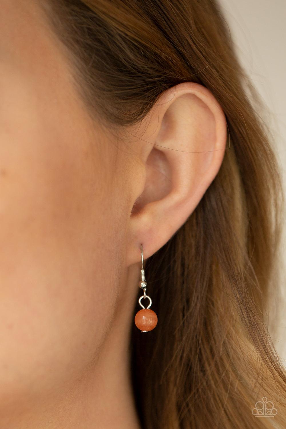 Paparazzi Accessories Aura Allure - Orange Encased in square silver fittings, a dewy collection of orange cat's eye stones gradually increase in size as they link below the collar for a whimsical pop of color. Features an adjustable clasp closure. Sold as