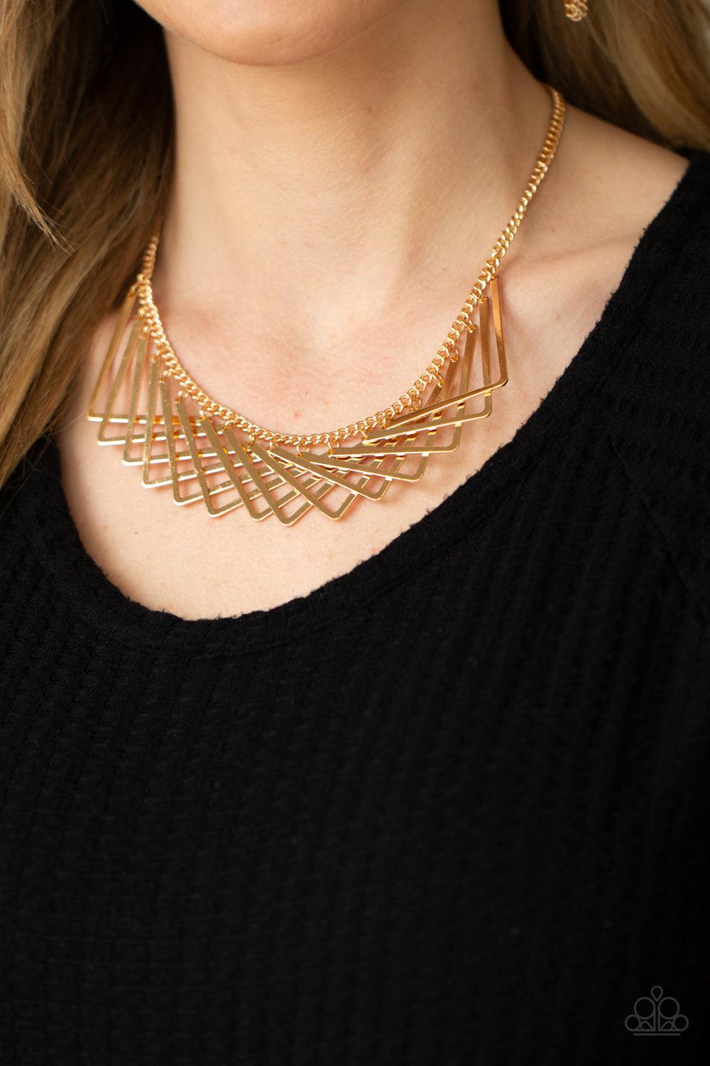 Paparazzi Accessories Metro Mirage - Gold A shiny collection of gold V-shape frames delicately overlap below the collar, creating an edgy optical illusion. Features an adjustable clasp closure. Sold as one individual necklace. Includes one pair of matchin