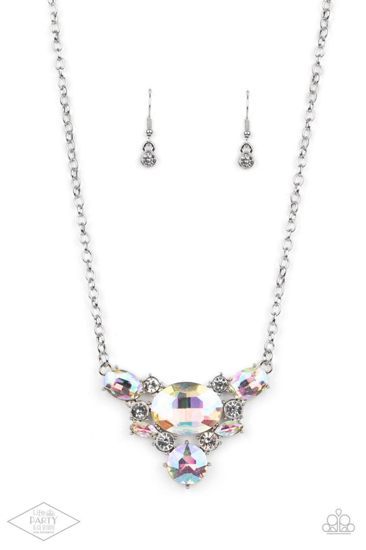 Paparazzi Accessories Cosmic Coronation - Multi Featuring a UV shimmer, oversized iridescent gems and glassy white rhinestones delicately coalesce into a v-shaped pendant below the collar for over-the-top glamour. Features an adjustable clasp closure. Sol