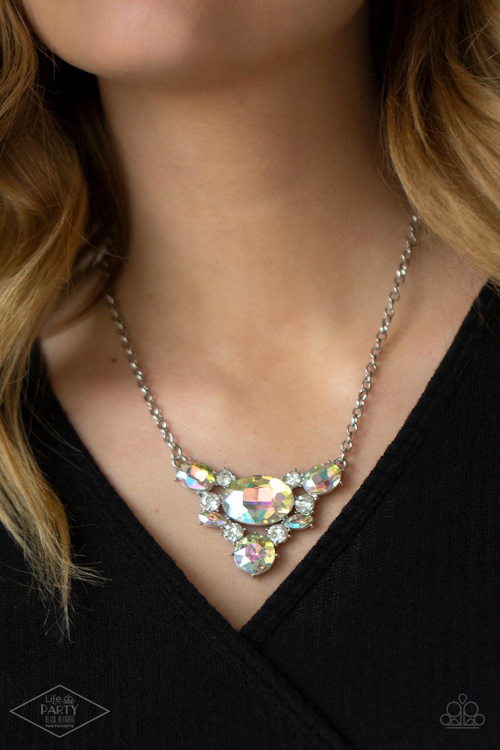 Paparazzi Accessories Cosmic Coronation - Multi Featuring a UV shimmer, oversized iridescent gems and glassy white rhinestones delicately coalesce into a v-shaped pendant below the collar for over-the-top glamour. Features an adjustable clasp closure. Sol