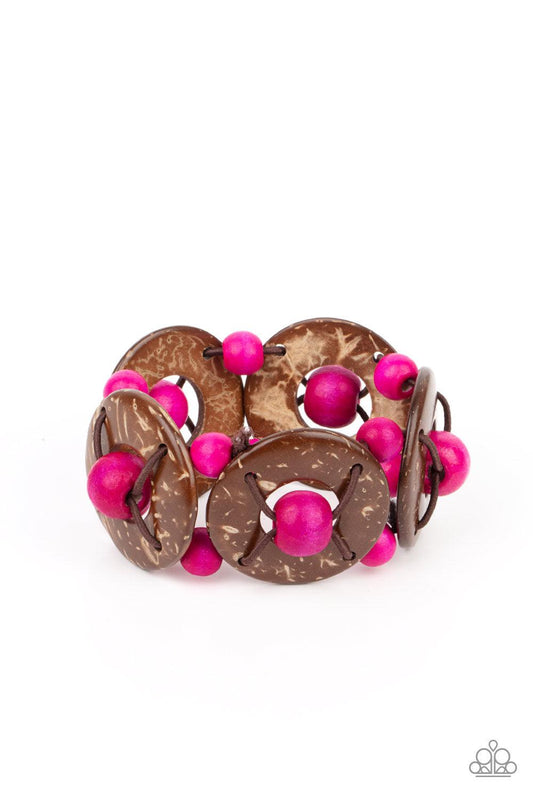 Paparazzi Accessories Island Adventure - Pink An oversized collection of pink wooden beads and distressed brown wooden discs are threaded along stretchy bands that decoratively weave around the wrist for a summery flair. Sold as one individual bracelet. J