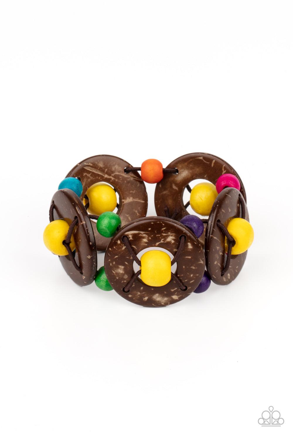 Paparazzi Accessories Island Adventure - Multi An oversized collection of multicolored beads and distressed brown wooden discs are threaded along stretchy bands that decoratively weave around the wrist for a summery flair. Sold as one individual bracelet.