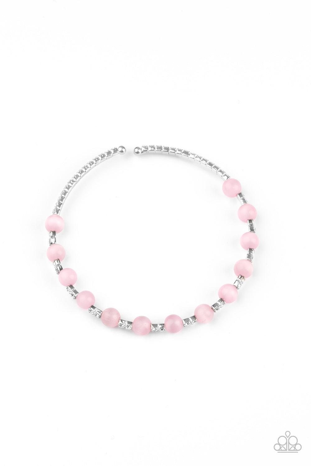 Paparazzi Accessories Tea Party Twinkle - Pink Glassy pink cat's eye stones are fitted in place along a dainty strand of glassy white rhinestones, creating a twinkly cuff around the wrist. Sold as one individual bracelet Jewelry