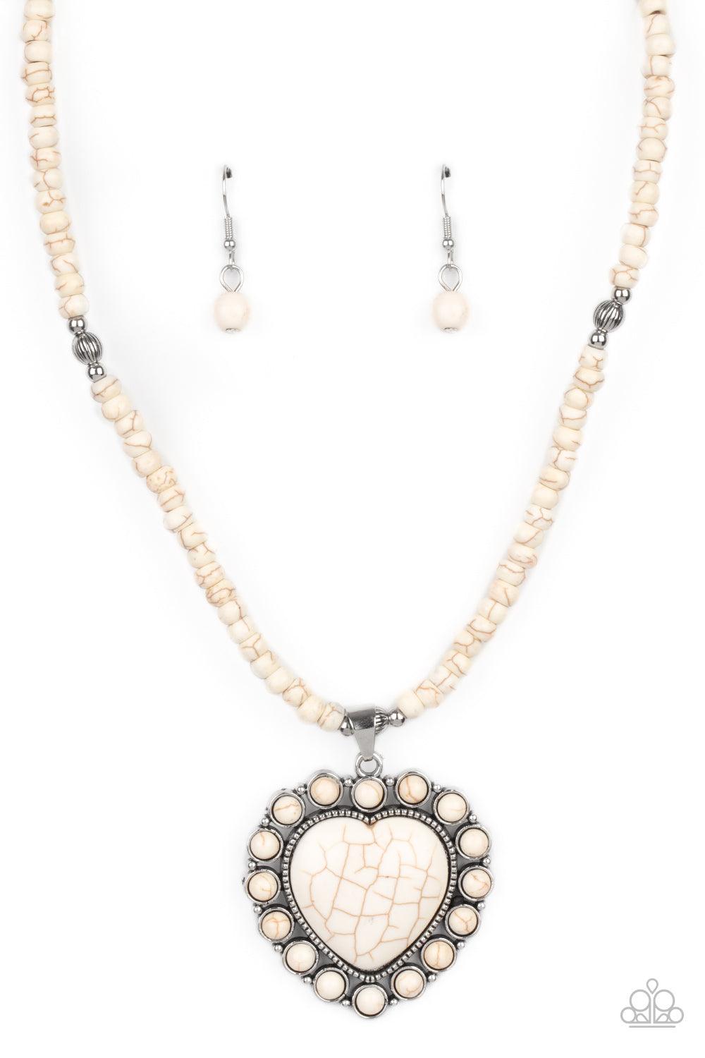 Paparazzi Accessories A Heart Of Stone - White Bordered by dainty white stones, an oversized white stone heart pendant swings from the bottom of a white stone and silver beaded display below the collar for a flirtatiously earthy fashion. Features an adjus