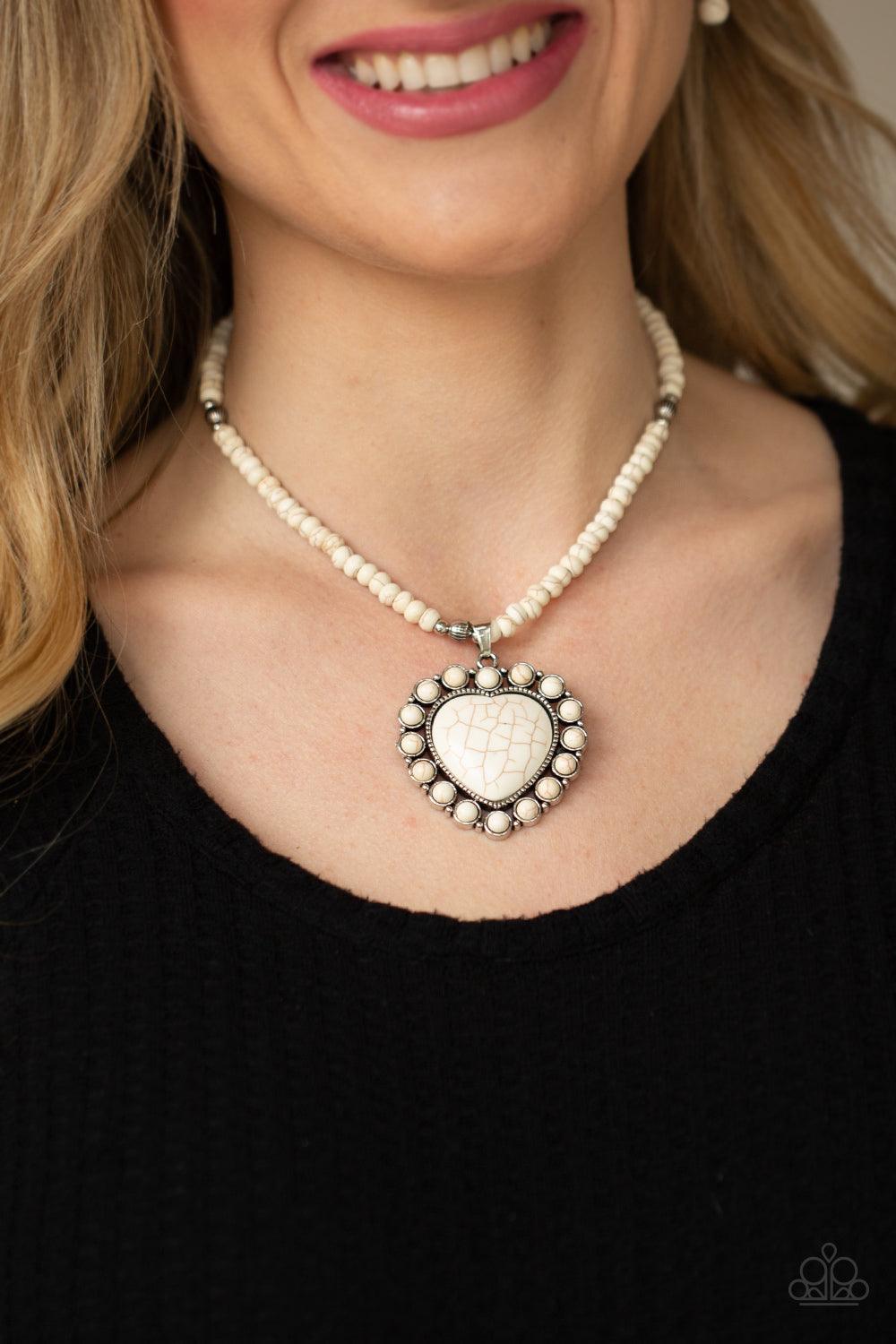 Paparazzi Accessories A Heart Of Stone - White Bordered by dainty white stones, an oversized white stone heart pendant swings from the bottom of a white stone and silver beaded display below the collar for a flirtatiously earthy fashion. Features an adjus