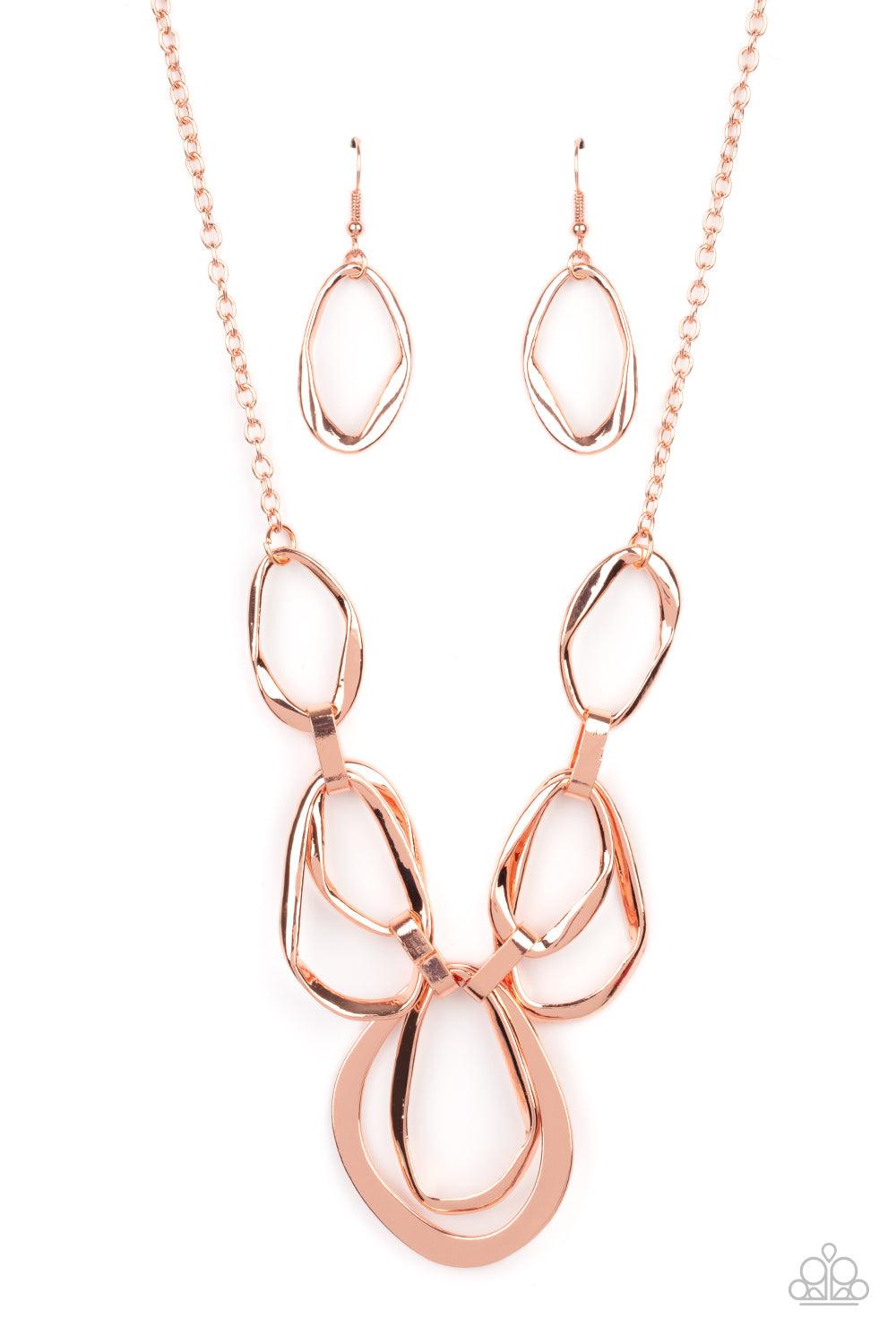 Paparazzi Accessories Prehistoric Heirloom - Copper An asymmetrical assortment of twisted and flattened shiny copper rings delicately link below the collar with oversized shiny copper fittings, creating an intense industrial display below the collar. Feat