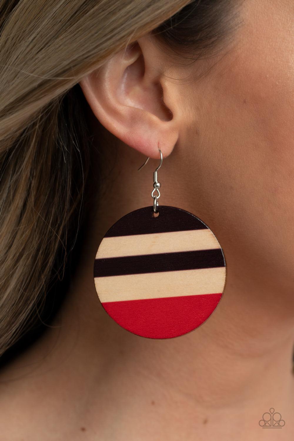 Paparazzi Accessories Yacht Party - Red The front of a shiny wooden disc is striped in purplish-brown and red accents, creating a colorful summery look. Earring attaches to a standard fishhook fitting. Sold as one pair of earrings. Jewelry