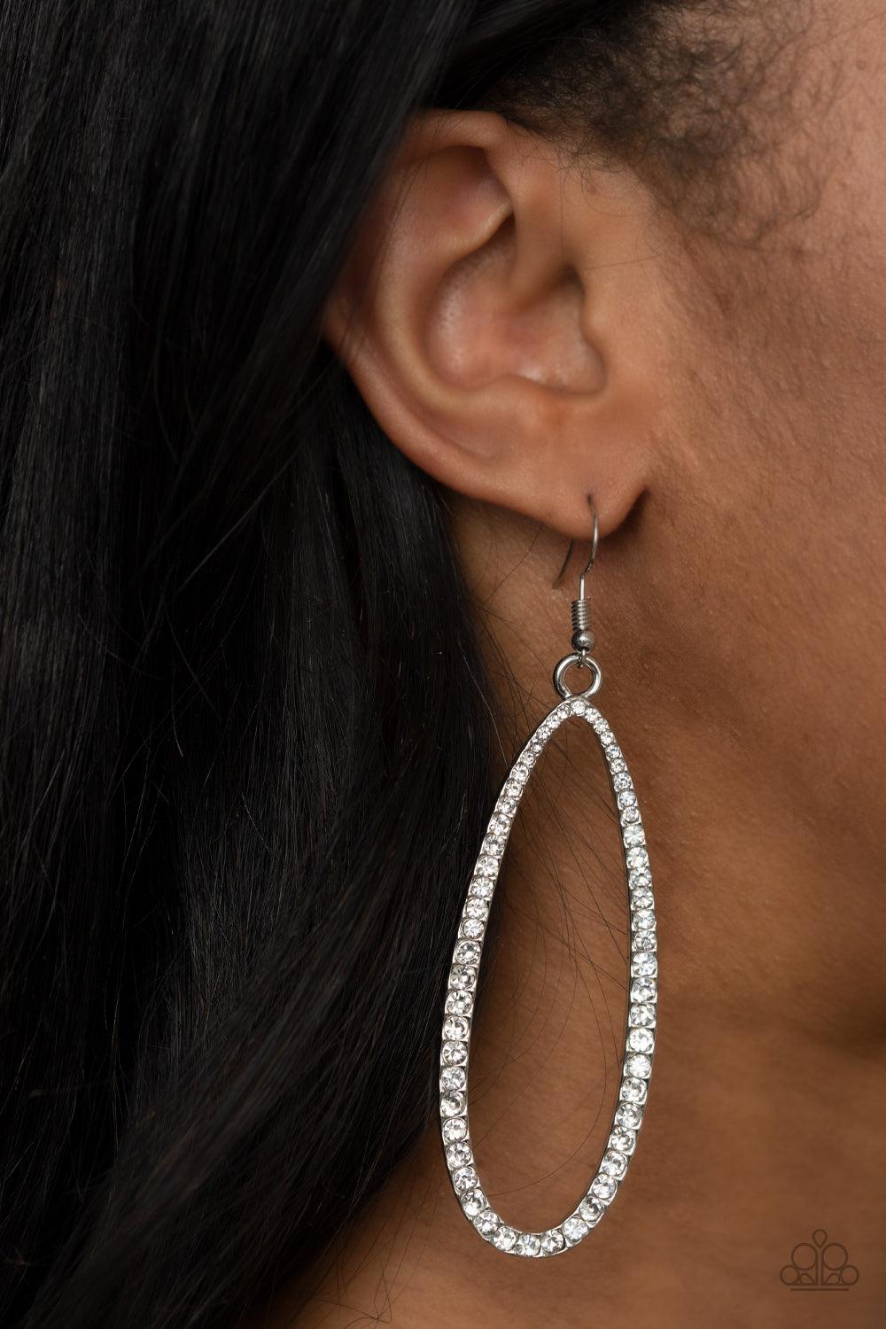 Paparazzi Accessories Dazzling Decorum - White The front of a lengthened silver oval frame is encrusted in glittery white rhinestones, creating a glamorous centerpiece. Earring attaches to a standard fishhook fitting. Sold as one pair of earrings. Jewelry