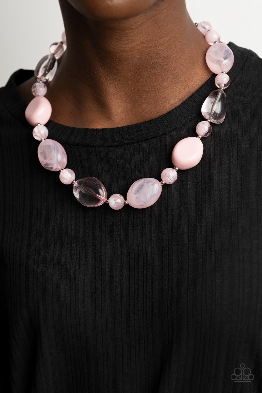 Paparazzi Accessories Staycation Stunner - Pink Featuring glassy, opaque, and solid finishes, an array of pink faux stone beads and dainty silver beads are threaded along an invisible wire below the collar, creating a colorful statement piece. Features an
