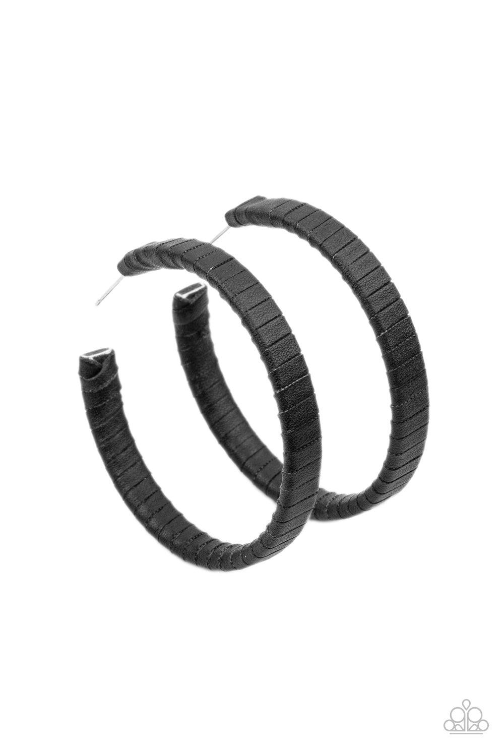 Paparazzi Accessories Leather-Clad Legend - Black A black leather lace wraps around a thick silver hoop, creating an edgy display. Earring attaches to a standard post fitting. Hoop measures approximately 2 1/2" in diameter. Sold as one pair of hoop earrin