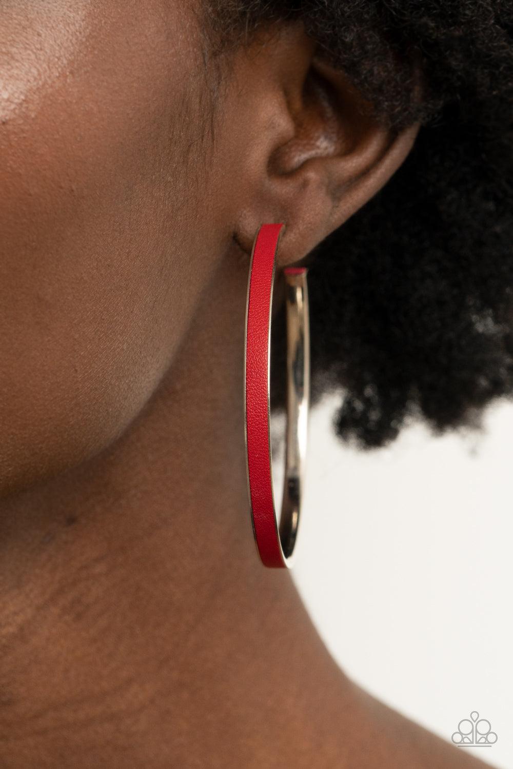 Paparazzi Accessories Fearless Flavor - Red A red leather lace is pressed along the indented spine of a silver hoop, creating a bold pop of color. Earring attaches to a standard post fitting. Hoop measures approximately 2 1/4" in diameter. Sold as one pai